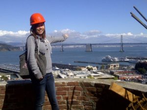 A high school student in AFSF's Build SF program looks out from their mentor's work site overlooking the SF Bay Bridge