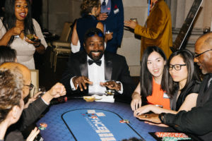 Picture of attendees at the poker table during 2023 Beaux Arts Ball